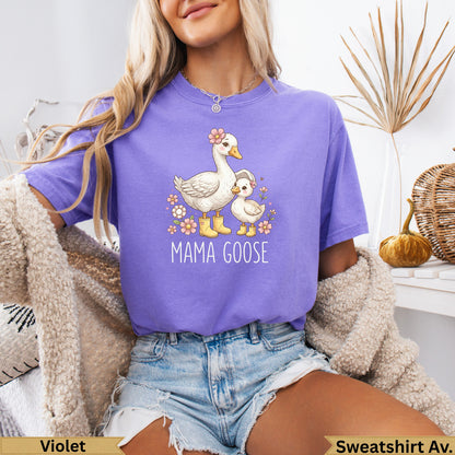 Purple t-shirt with mama goose and duckling graphic and text.