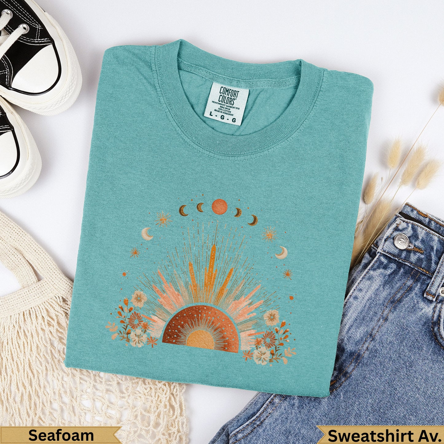 Teal Comfort Colors sweatshirt with sun and moon celestial graphic.