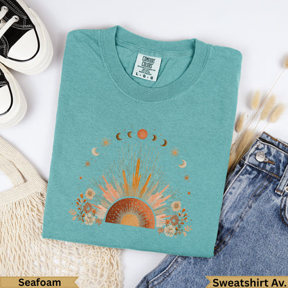 Teal Comfort Colors sweatshirt with sun and moon celestial graphic.
