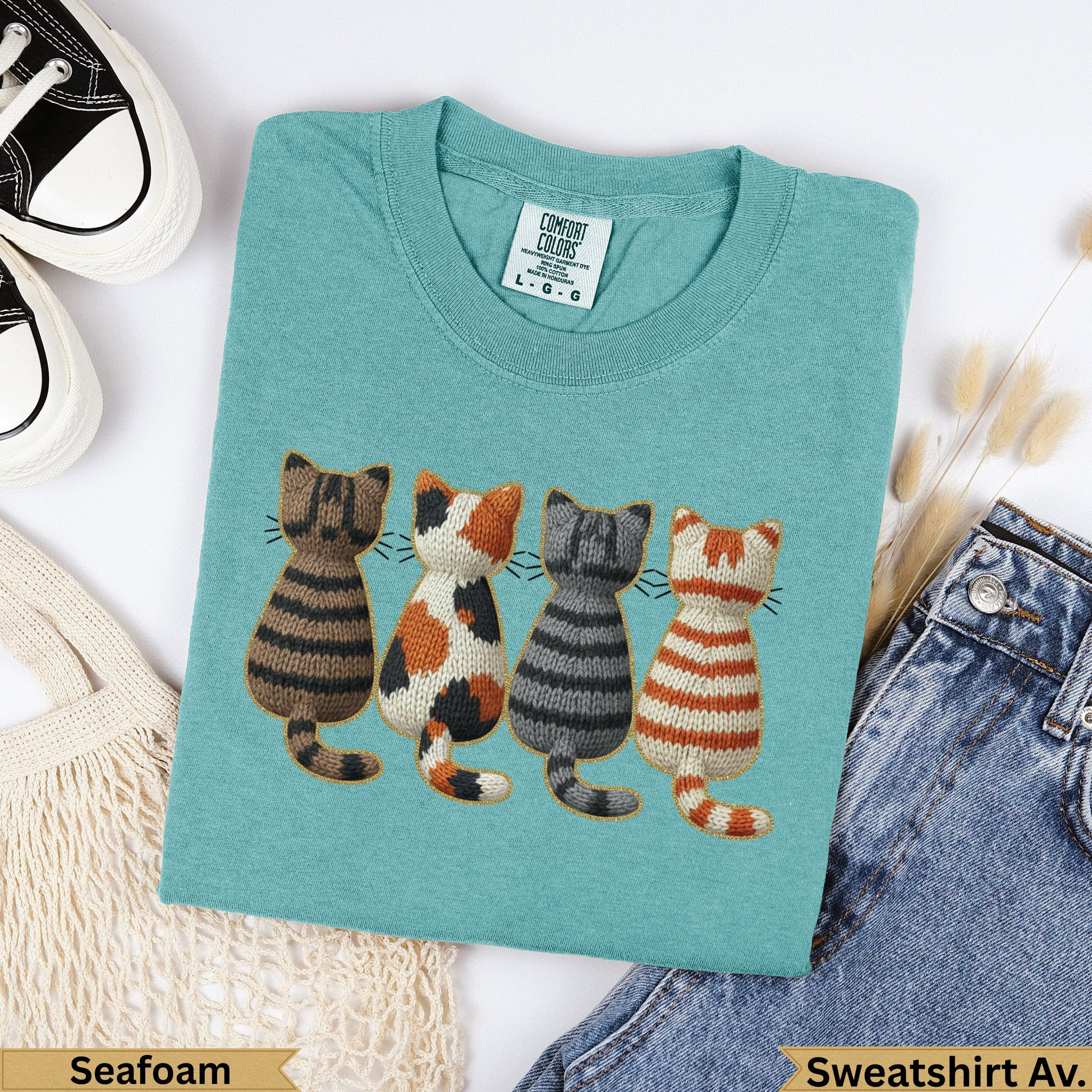 Teal sweatshirt with embroidered striped cats and "Seafoam" text.