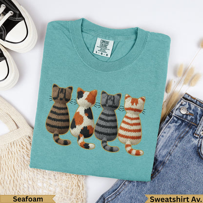 Teal sweatshirt with embroidered striped cats and "Seafoam" text.
