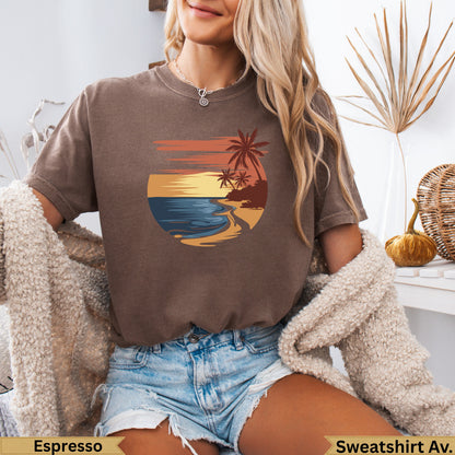 Brown sweatshirt featuring a vintage sunset beach scene with palm trees.