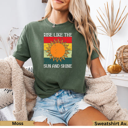 Green t-shirt with "Rise Like the Sun and Shine" text and sun graphic.