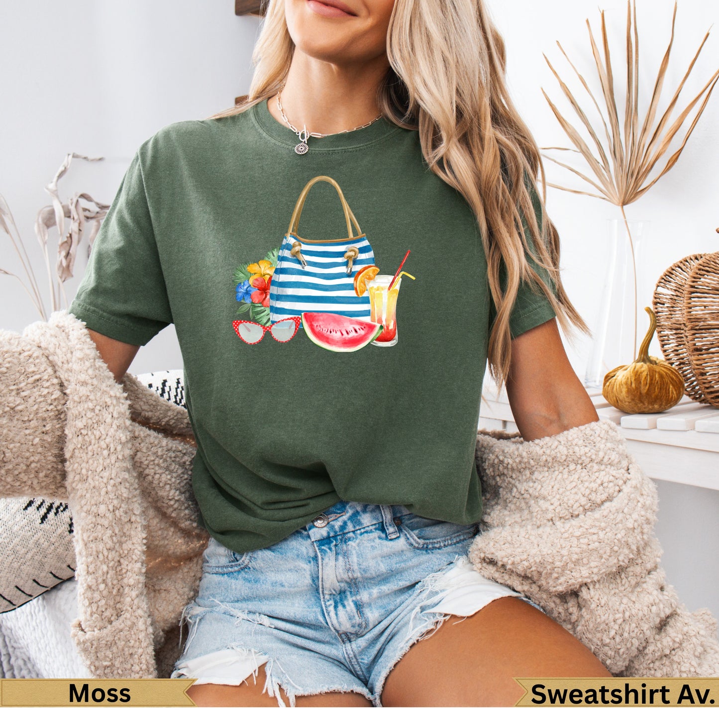 Green t-shirt with watercolor beach bag, sunglasses, and drinks graphic.
