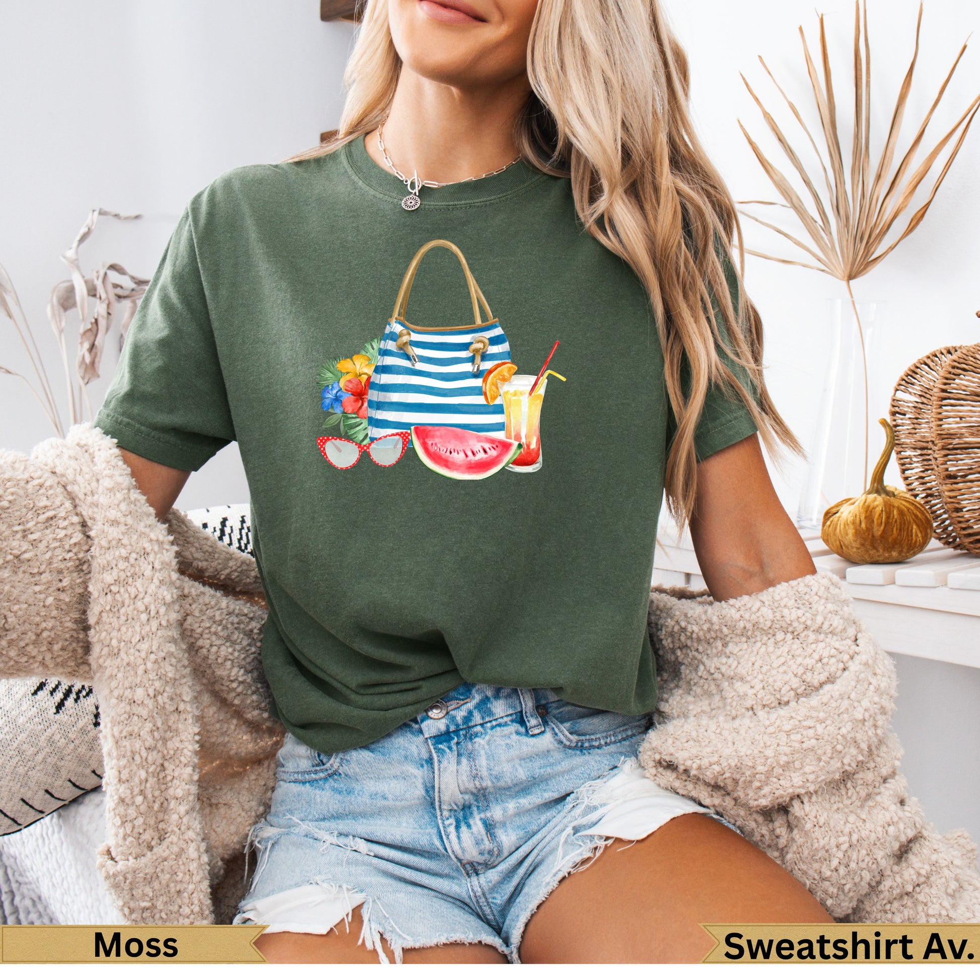Green t-shirt with watercolor beach bag, sunglasses, and drinks graphic.