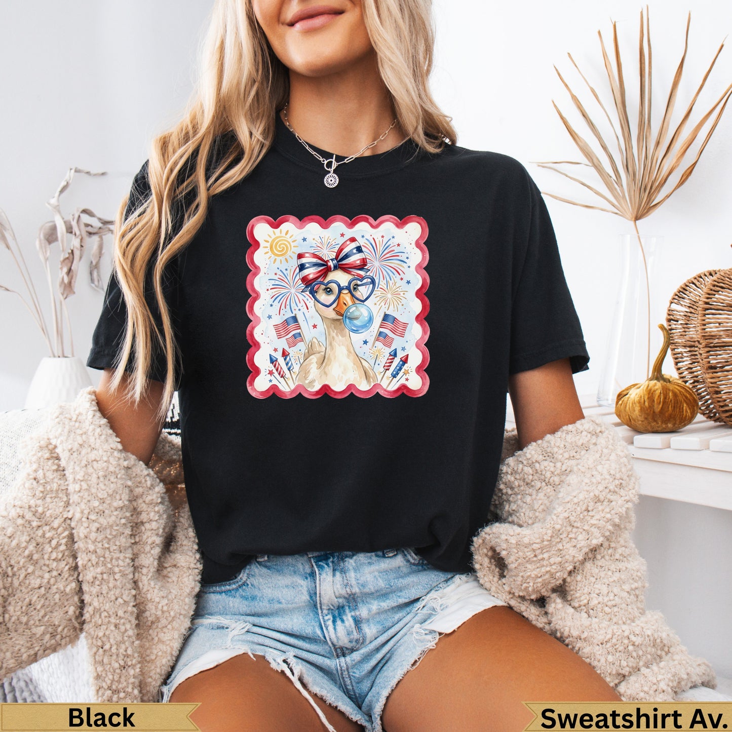 Black graphic t-shirt with patriotic duck wearing sunglasses and bow tie.