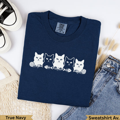 Navy t-shirt with five white cat illustrations, yarn balls, and fish skeletons.
