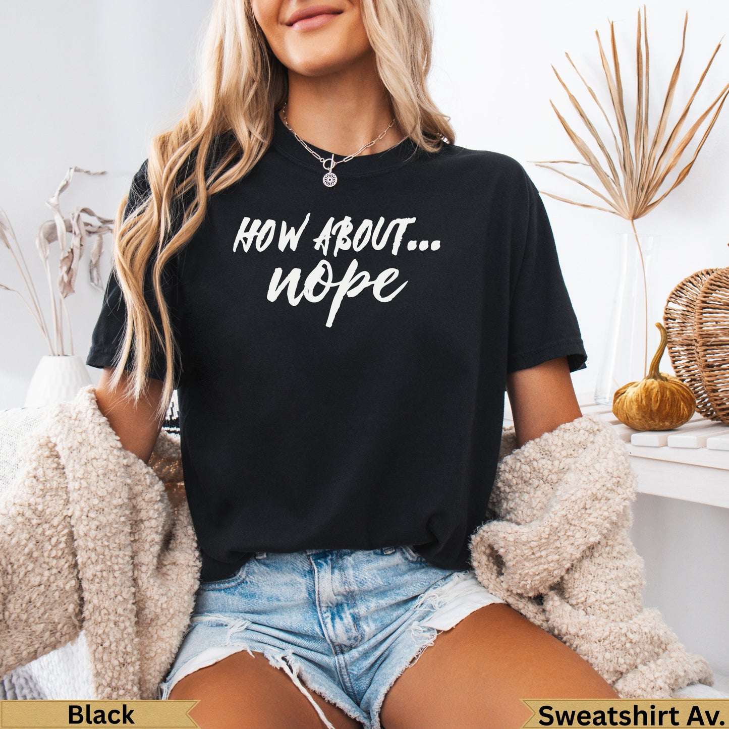 Black t-shirt with "HOW ABOUT... nope" text, worn by a model.