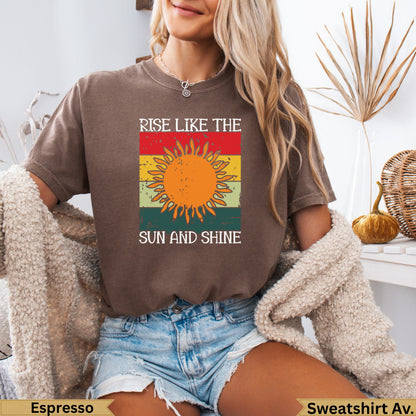 Brown t-shirt with "Rise Like the Sun and Shine" text and a sun graphic.