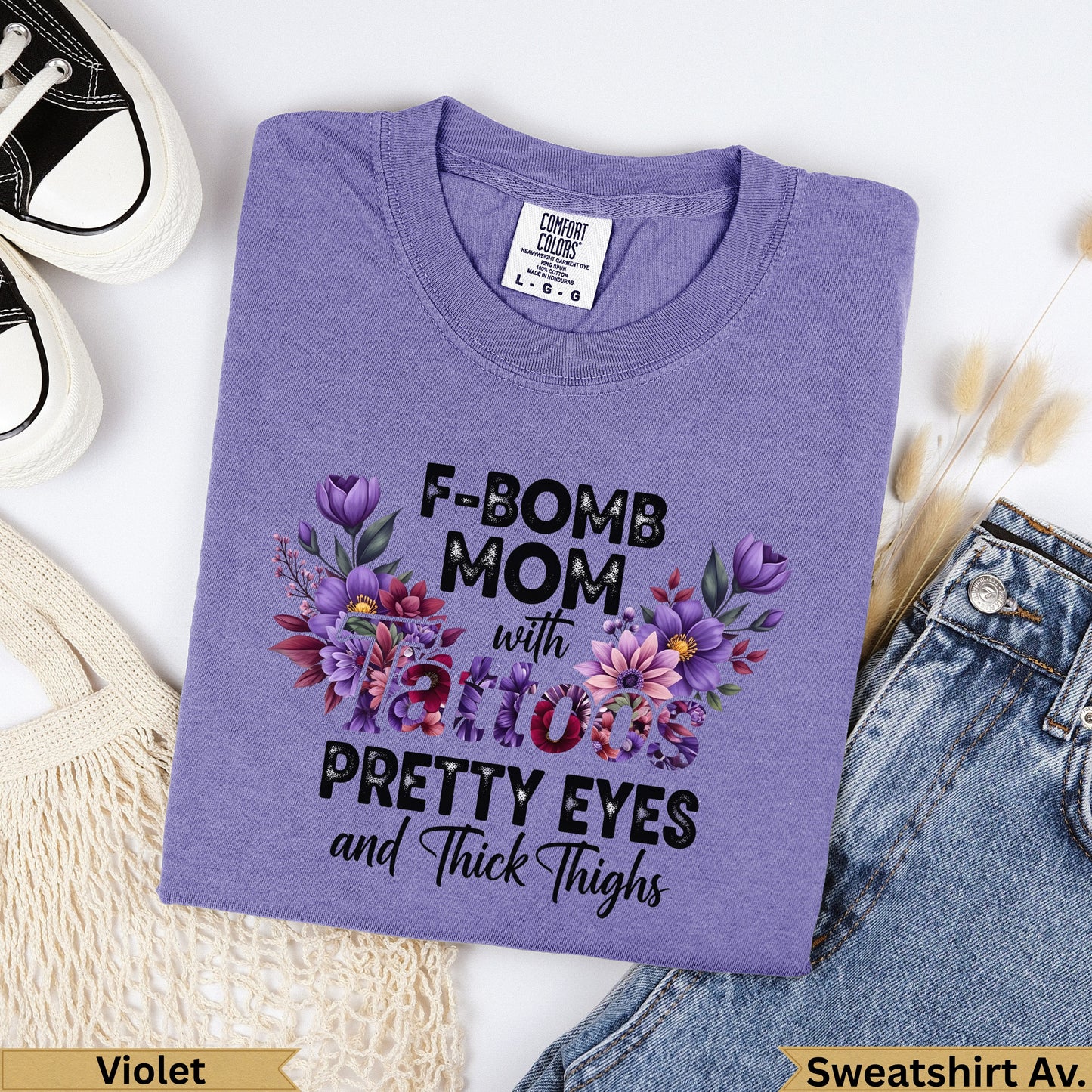 Purple t-shirt with "F-BOMB MOM with tattoos PRETTY EYES and Thick Thighs" graphic.