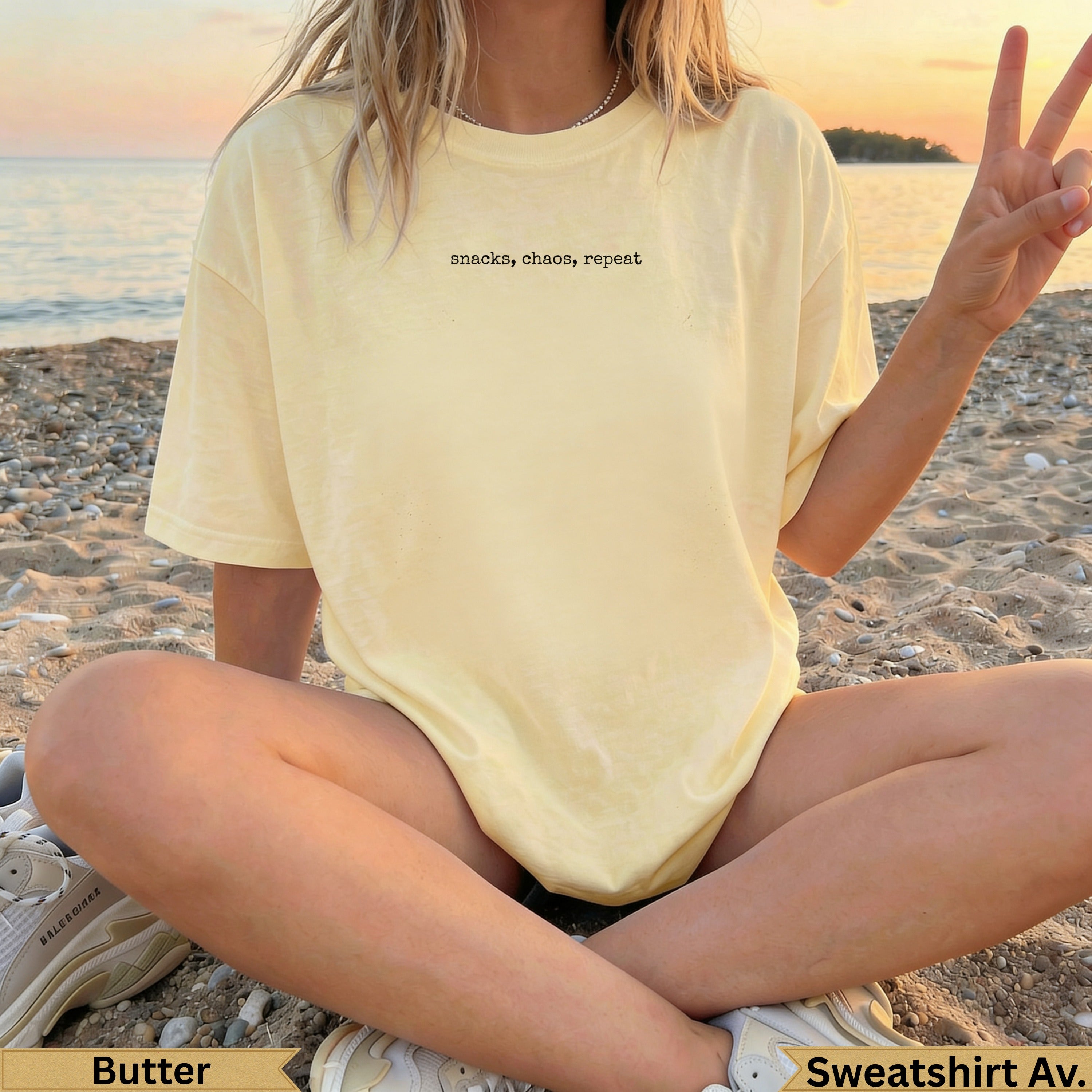 Light yellow t-shirt with black text "snacks, chaos, repeat" and peace sign.