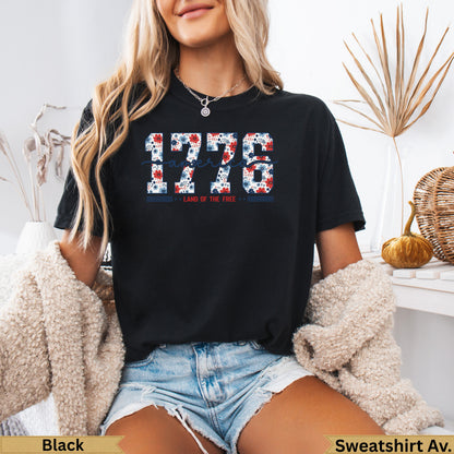 Black t-shirt with "1776 Land of the Free" graphic in red, white, and blue.