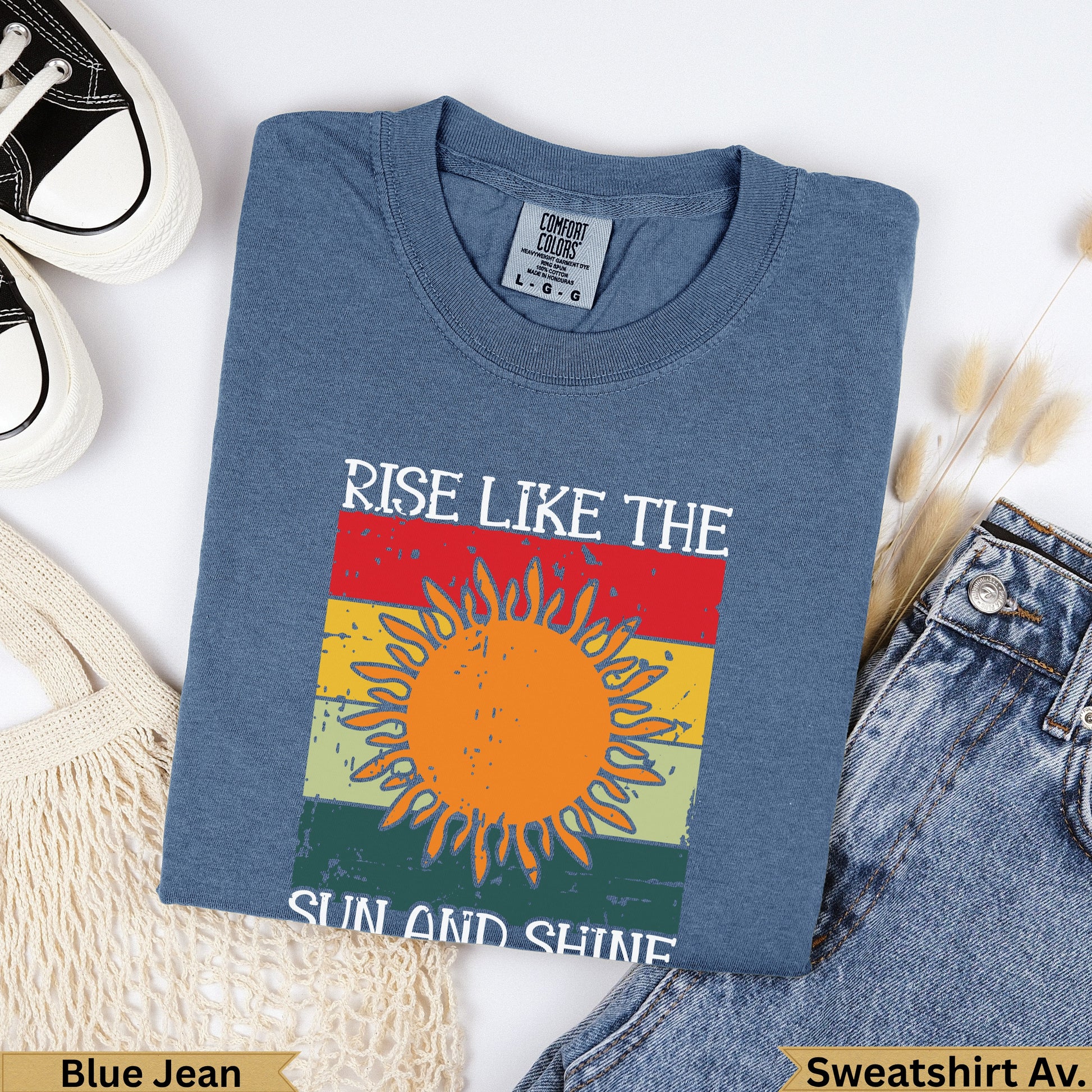 Blue Jean sweatshirt with "Rise Like the Sun and Shine" graphic.
