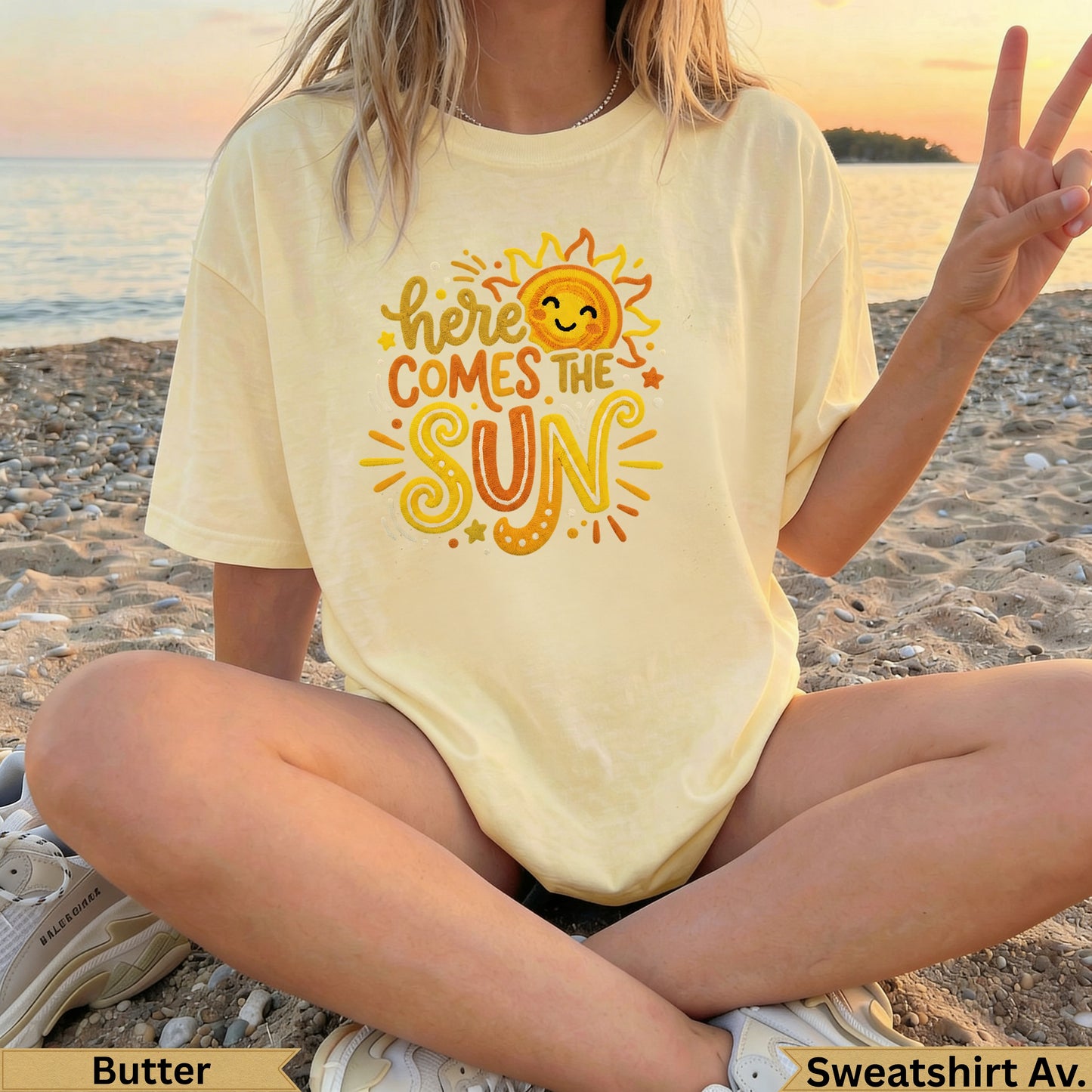 Yellow t-shirt with "Here Comes The Sun" graphic and smiling sun.