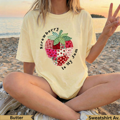 Yellow t-shirt with patchwork strawberry graphic and text "Strawberry Is My Jam".