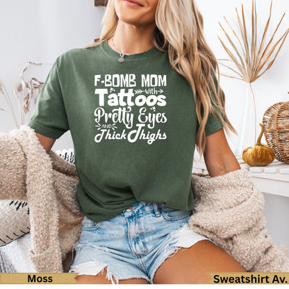 F-Bomb Mom with Tattoos Pretty Eyes Thick Thighs graphic tee in moss.