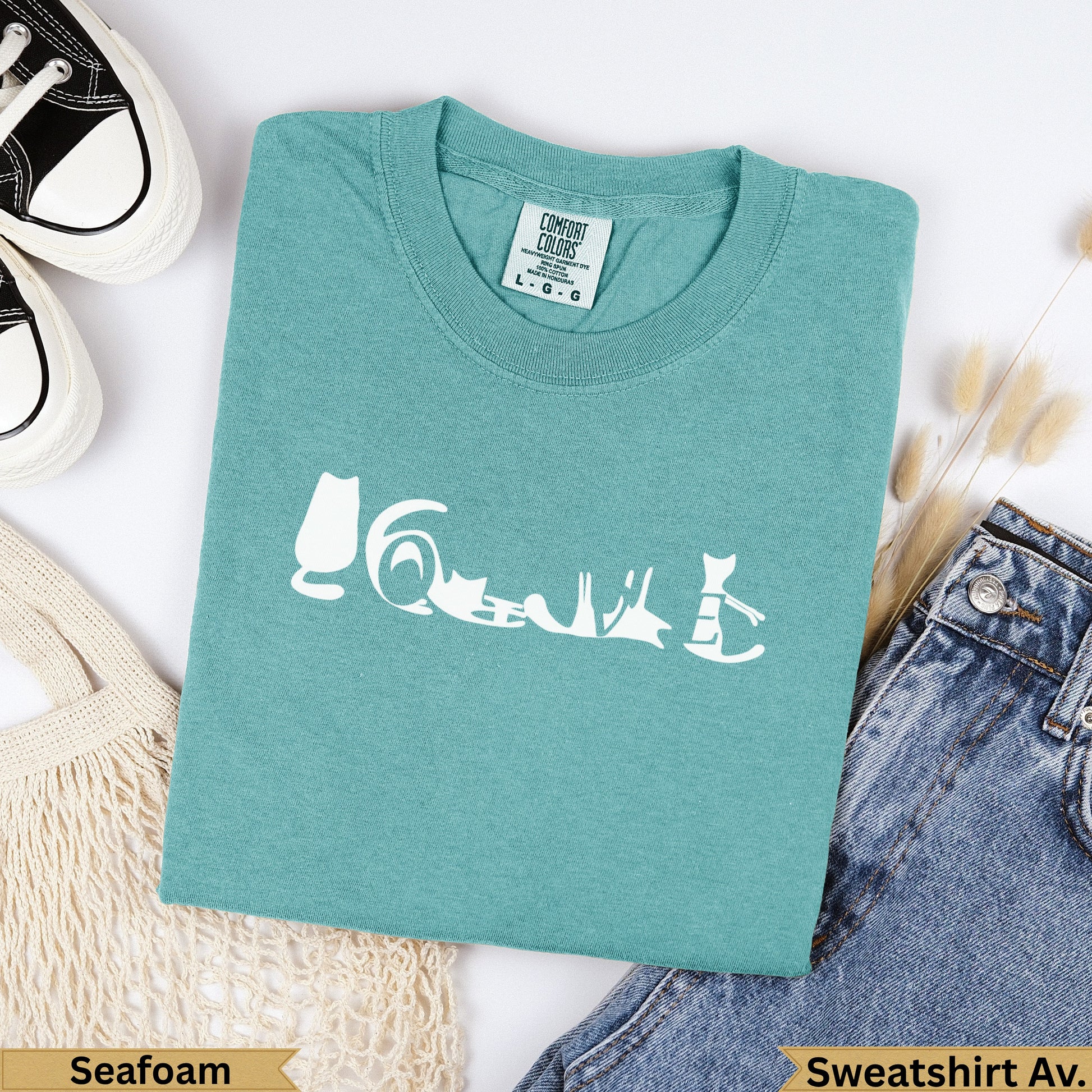 Teal Comfort Colors sweatshirt with white cat graphic and "Seafoam" label.