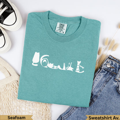 Teal Comfort Colors sweatshirt with white cat graphic and "Seafoam" label.
