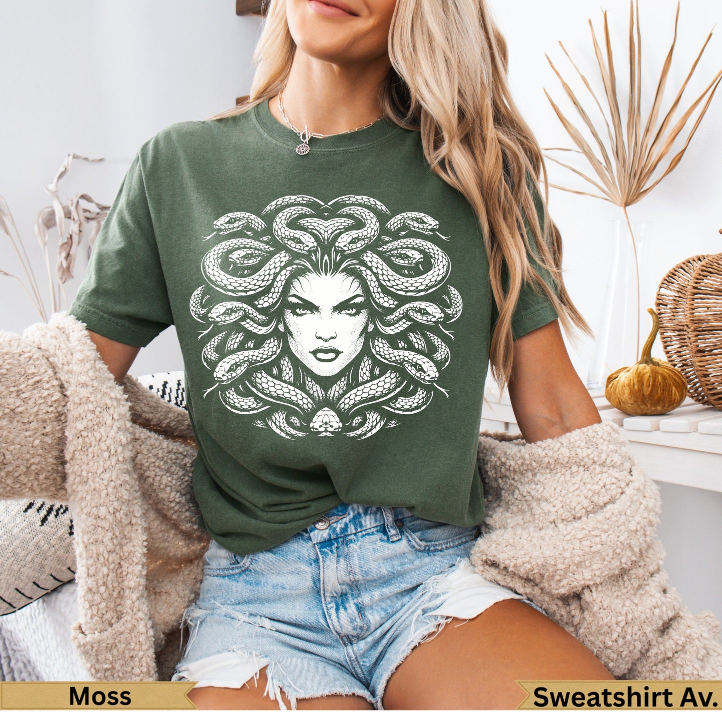 Green t-shirt with white Medusa graphic on the front.