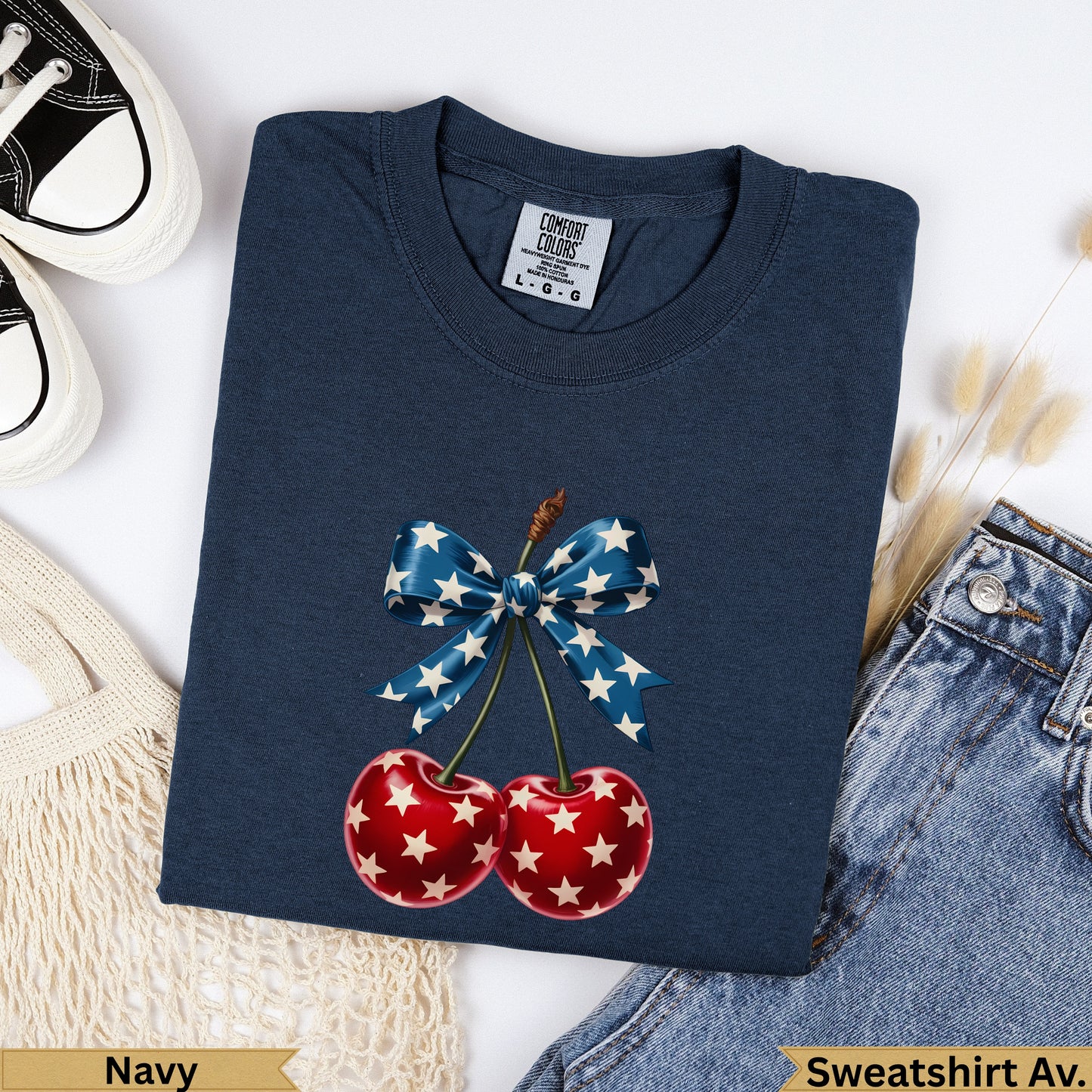 Navy Comfort Colors sweatshirt with red cherries and blue star bow graphic.