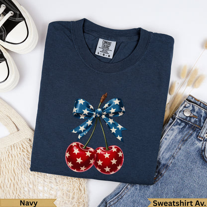 Navy Comfort Colors sweatshirt with red cherries and blue star bow graphic.