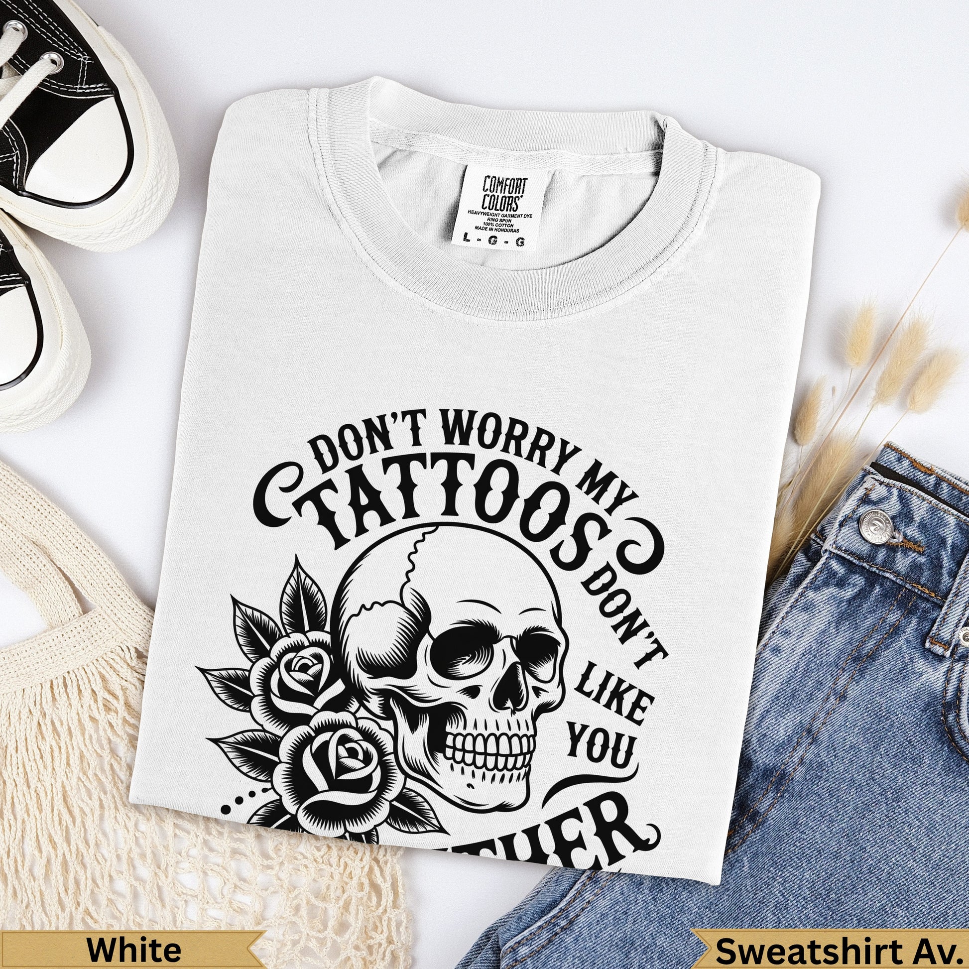 White t-shirt with skull and rose design, saying "Don't worry my tattoos don't like you".