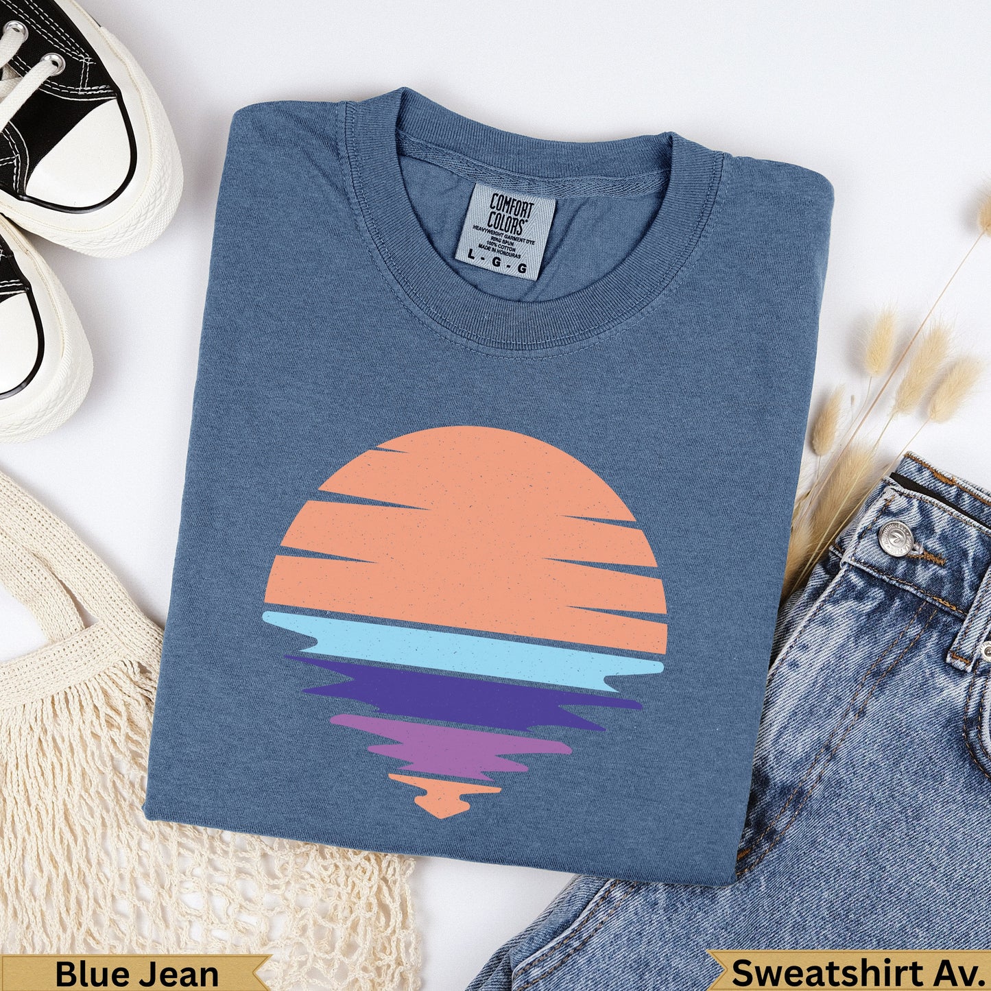 Blue Jean Comfort Colors sweatshirt with a sunset graphic over water.