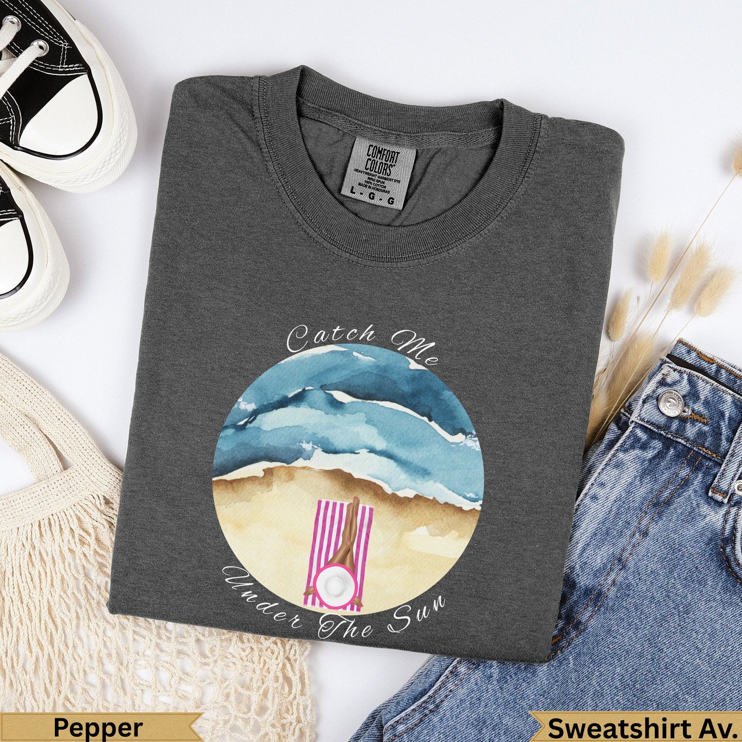 Dark gray t-shirt with "Catch Me Under The Sun" beach graphic.