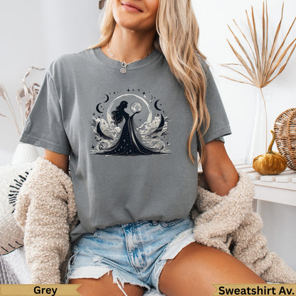 Grey t-shirt with celestial woman design, moons, stars, and clouds.