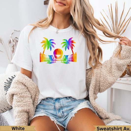 White t-shirt with rainbow palm trees and beach chairs graphic.