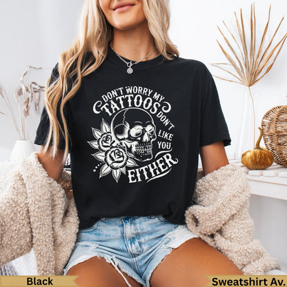 Black t-shirt with skull, roses, and text: "Don't worry my tattoos don't like you either".