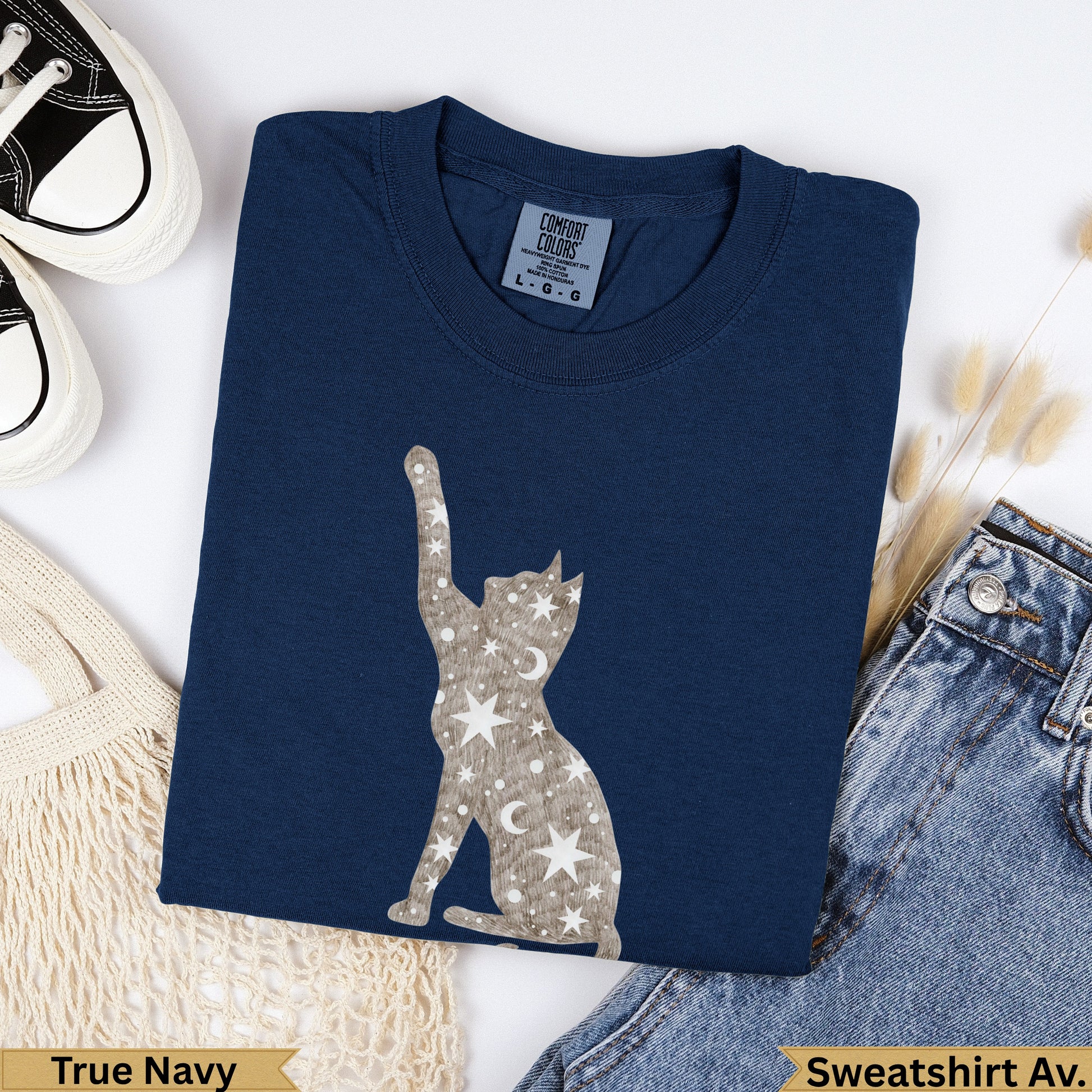 Navy blue cat graphic sweatshirt with celestial moon and star pattern.