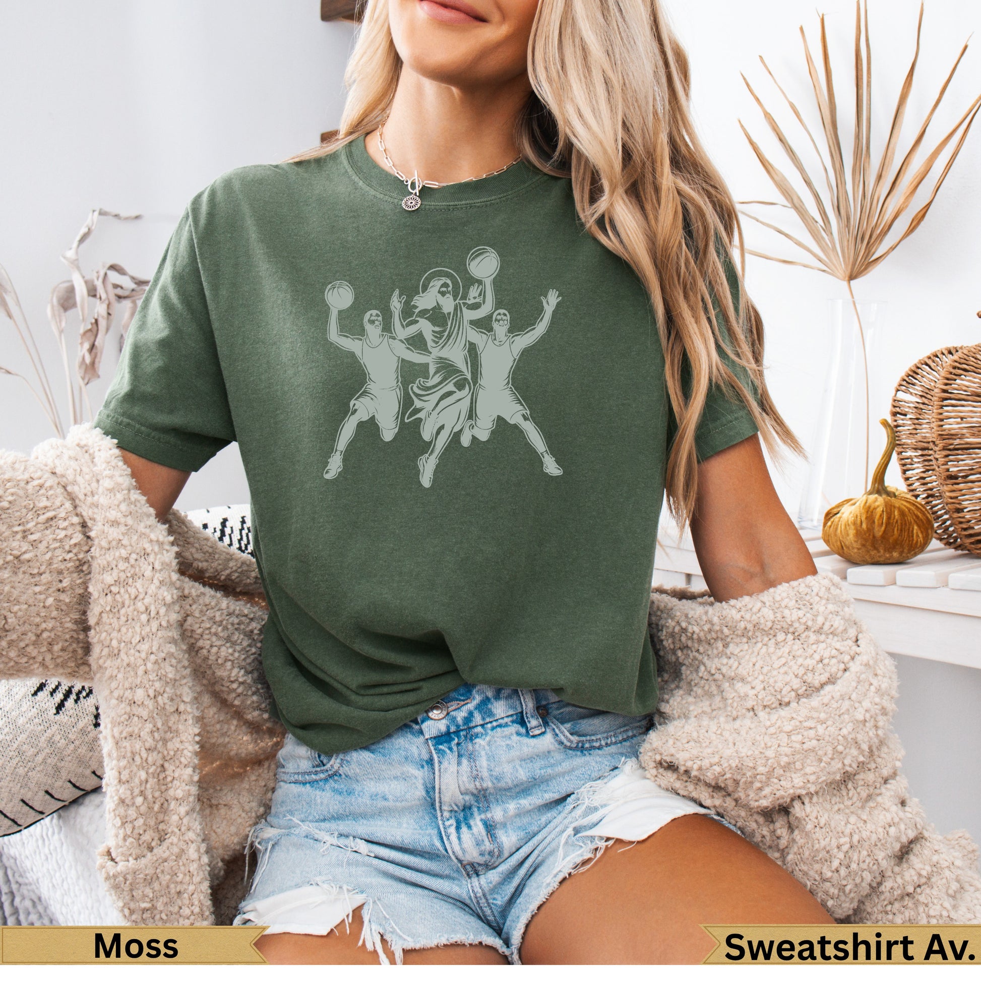 Olive green t-shirt with graphic of three figures playing basketball.