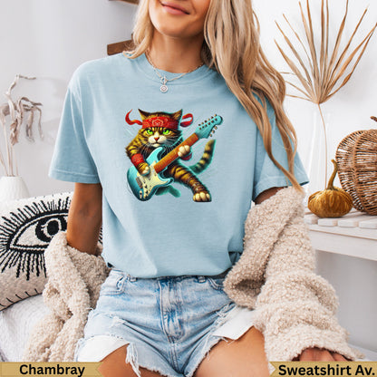 Blue t-shirt with a cartoon cat playing a red electric guitar, wearing a red bandana.