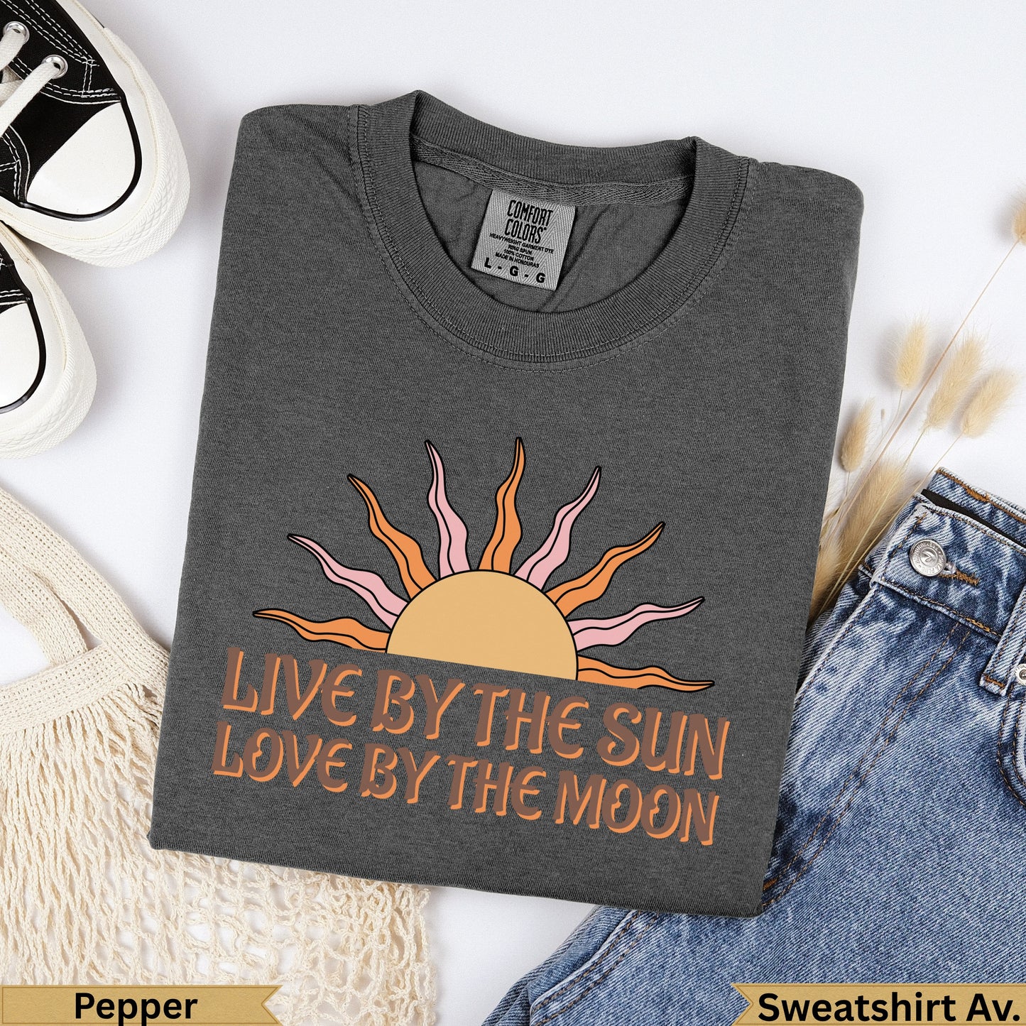 Dark grey t-shirt with sun and moon graphic and "Live by the sun love by the moon" text.