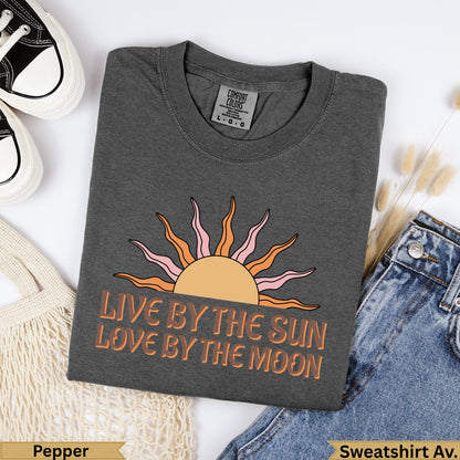 Dark grey t-shirt with sun and moon graphic and "Live by the sun love by the moon" text.
