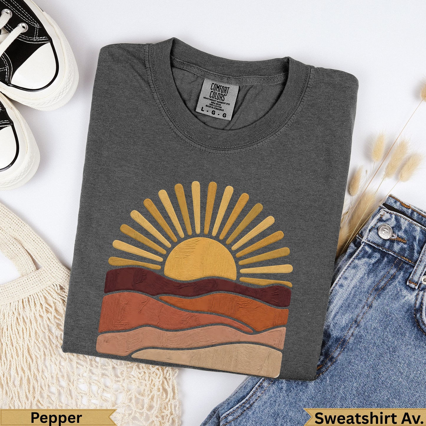 Dark gray sweatshirt with a retro sun and layered hills graphic.