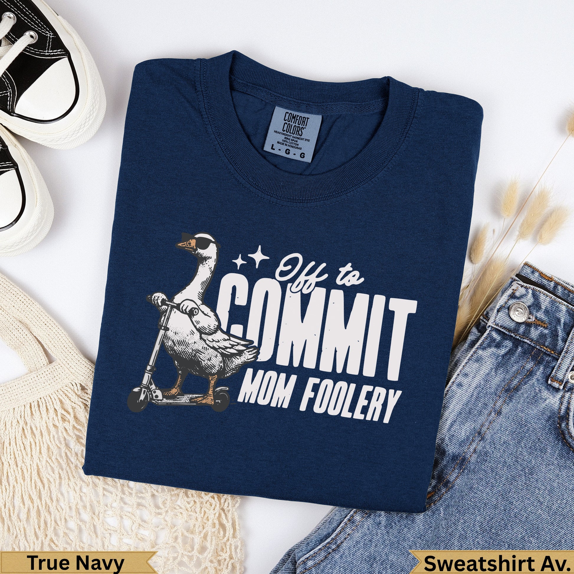 Navy t-shirt with a goose on a scooter and "Off to Commit Mom Foolery" text.