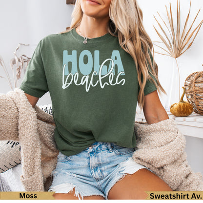 Green t-shirt with "Hola beaches" in light blue text.