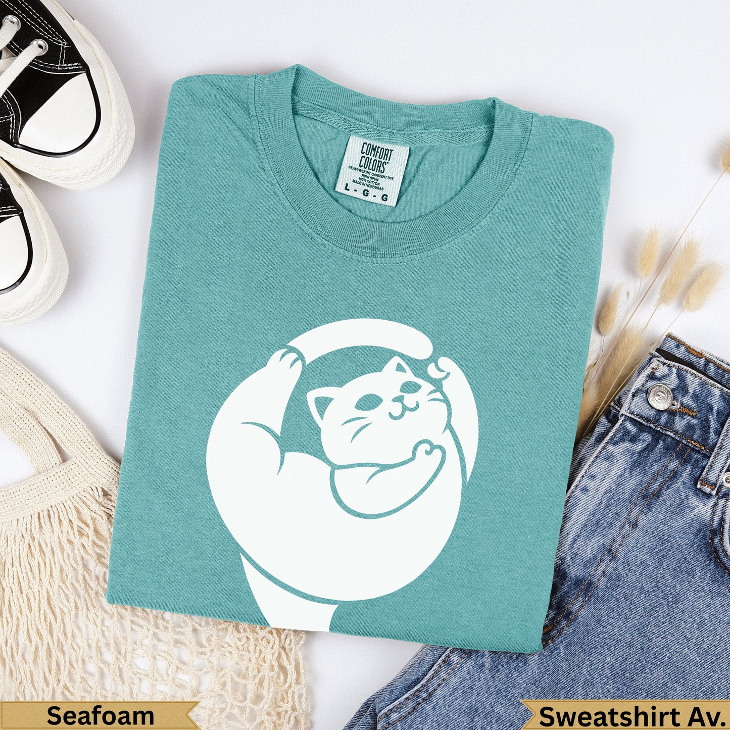 Teal Comfort Colors sweatshirt with white cat graphic, "Seafoam" and "Sweatshirt Av." text.