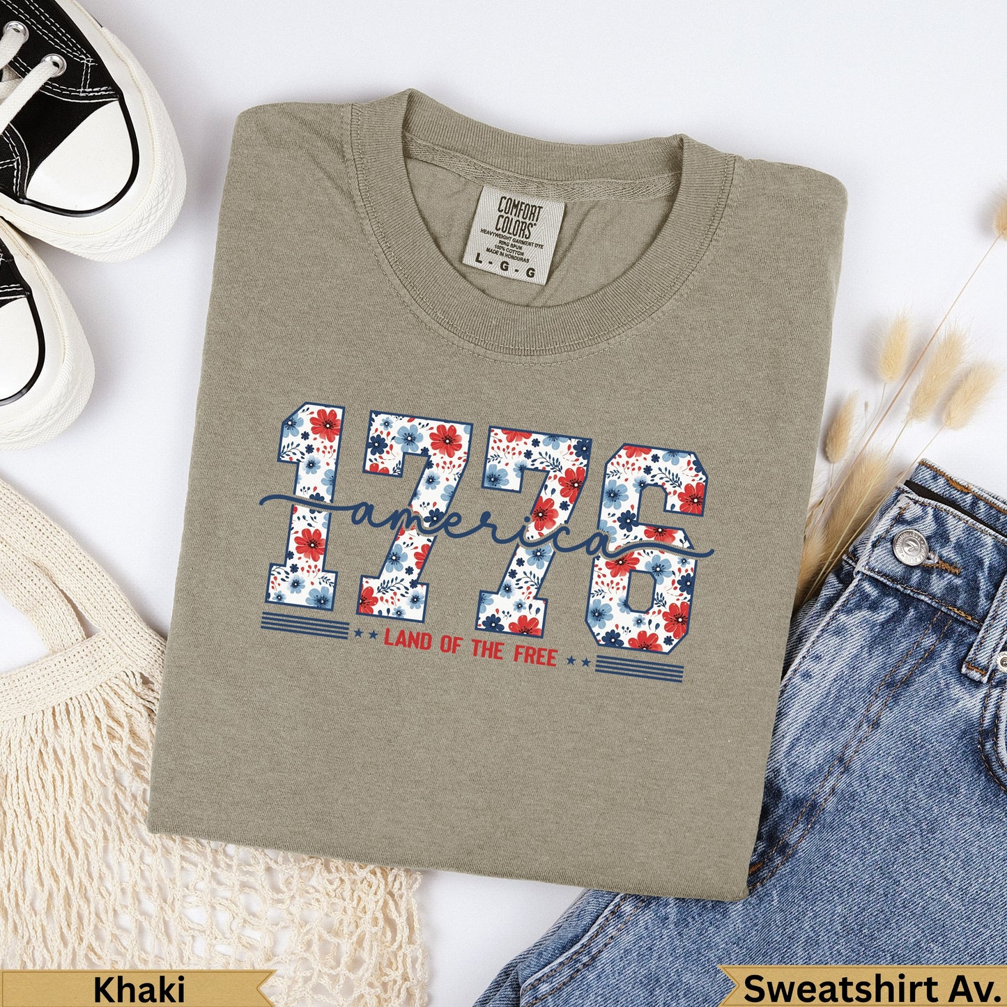 Khaki sweatshirt with "1776 Land of the Free" graphic in red and blue floral letters.
