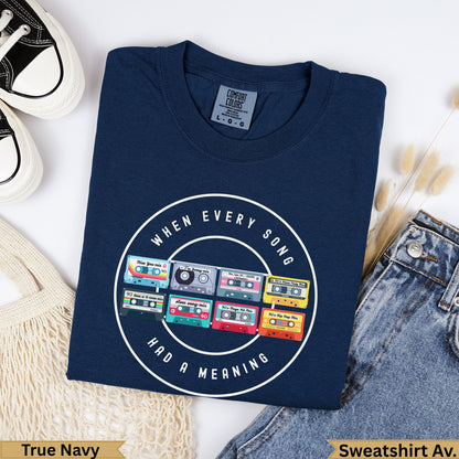 Navy t-shirt with "When Every Song Had A Meaning" and colorful 90s mixtape graphics.
