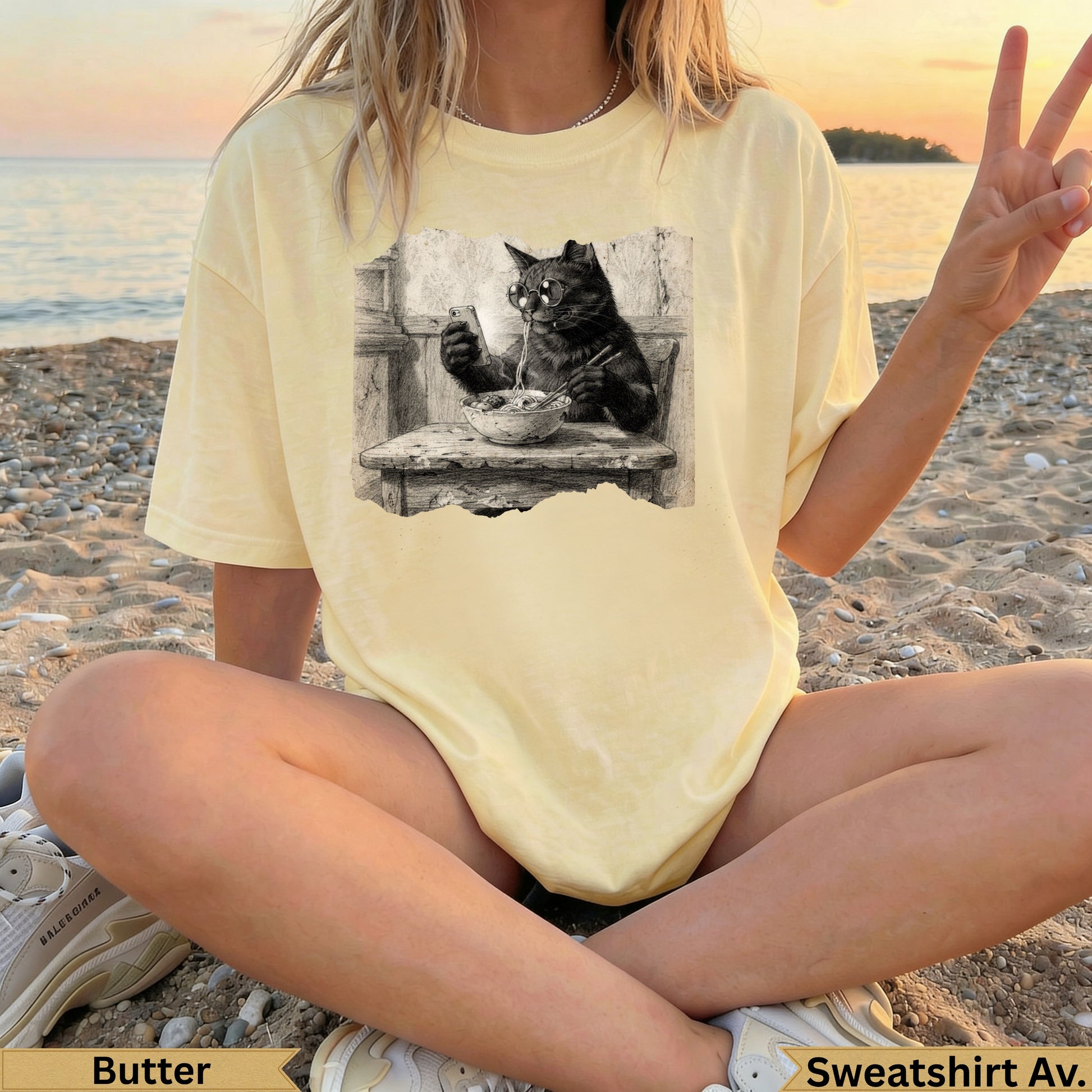 Black cat eating from a bowl on a graphic t-shirt.