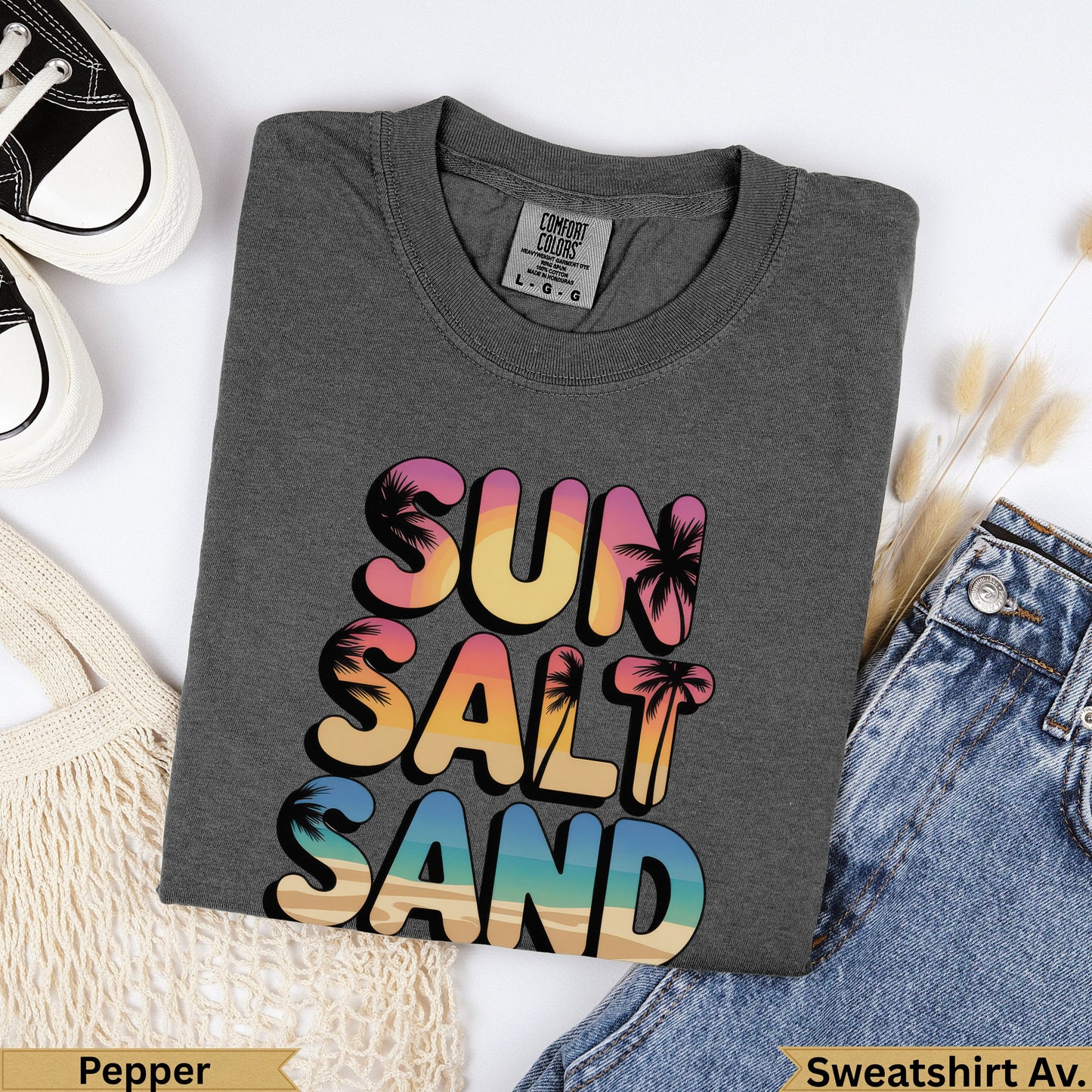 Dark gray sweatshirt with "Sun Salt Sand" text in colorful ombre letters.