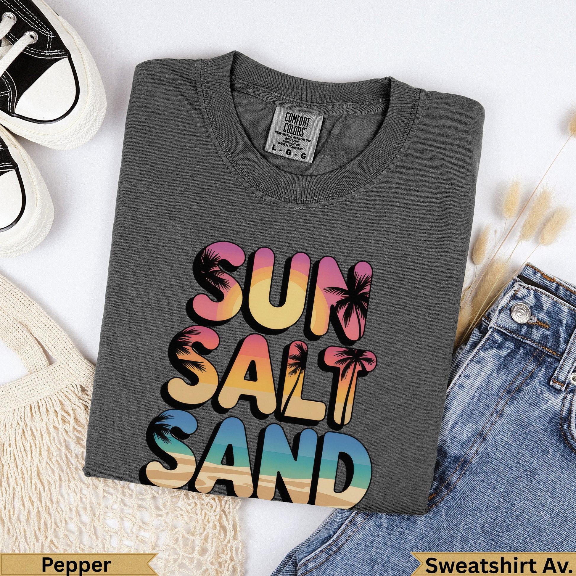 Dark gray sweatshirt with "Sun Salt Sand" text in colorful ombre letters.