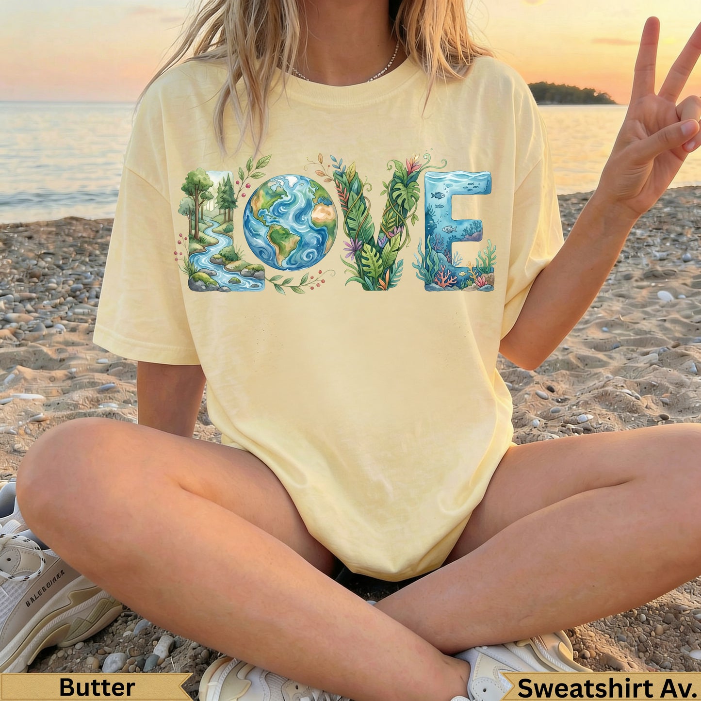 Light yellow t-shirt with "LOVE" design featuring earth, trees, and fish.