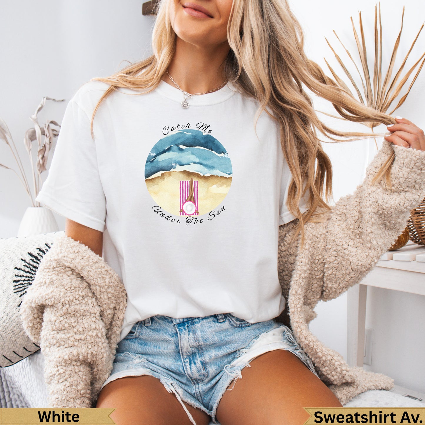 White t-shirt with watercolor beach scene and text "Catch Me Under The Sun".