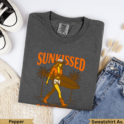 Dark grey t-shirt with "SUNKISSED" text and woman carrying surfboard design.