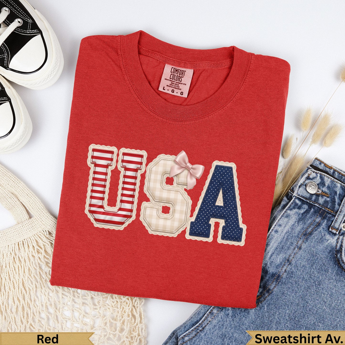 Red sweatshirt with "USA" in patriotic patchwork, bow.