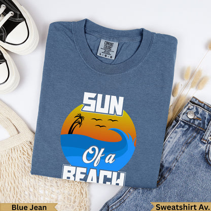 Blue t-shirt with "SUN Of a BEACH" graphic featuring a sunset over waves.